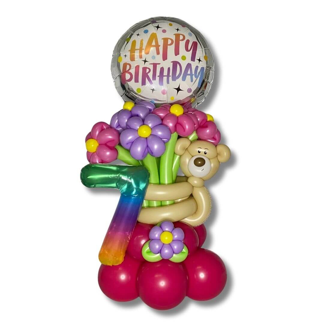 Bear Hug Birthday Flower Balloon Bouquet features an adorable bear holding pink and purple flowers, a 14 inch Rainbow Jelly Number balloon and a 17 inch Happy Birthday Foil Balloon.