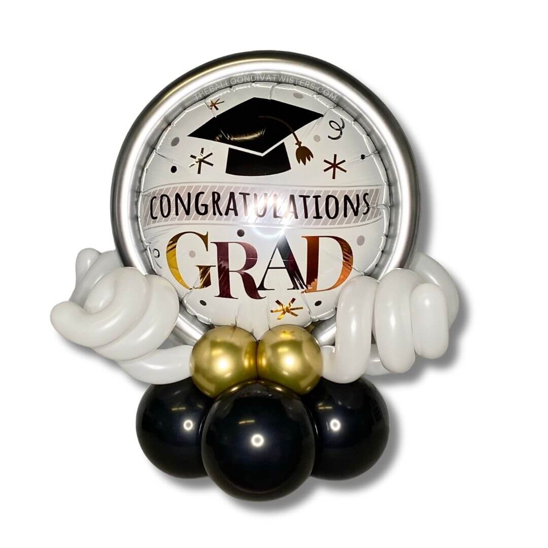 Congratulations Grad Cap & Confetti Balloon Centerpiece. This centerpiece is adorned with chrome gold, rose gold, and silver balloon accents.