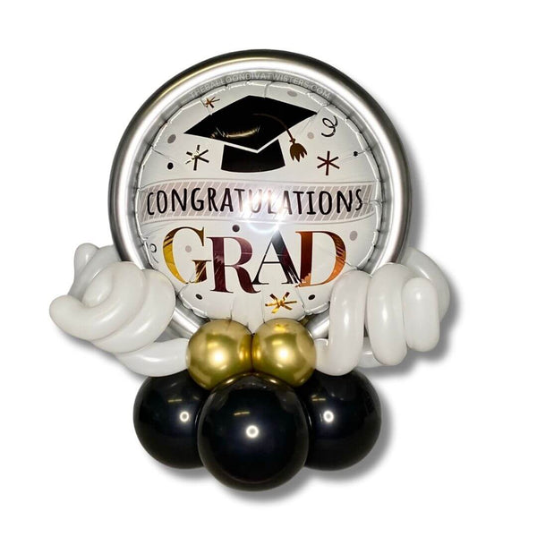 Congratulations Grad Cap & Confetti Balloon Centerpiece. This centerpiece is adorned with chrome gold, rose gold, and silver balloon accents.