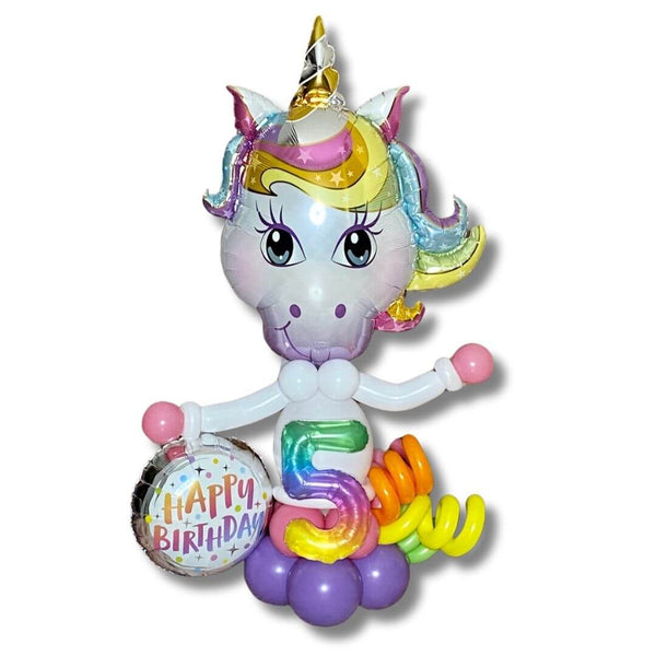 Magical Unicorn Birthday Balloon Column! Standing at 3-4 feet tall, this colorful column features a happy birthday foil and jelly number foil balloon, along with a fun rainbow balloon curls tail.