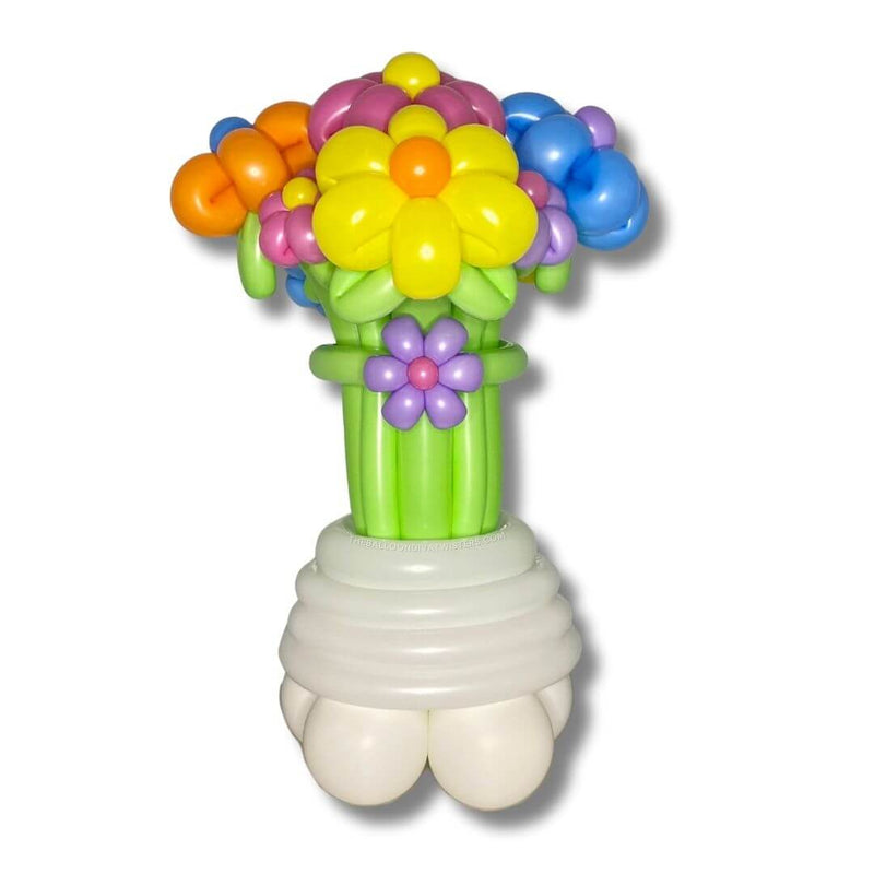 Spring Blooms Flower Balloon Bouquet is a 2 feet tall balloon design with colorful yellow, orange, blue, lilac, and pick balloon flowers with lime green stems.